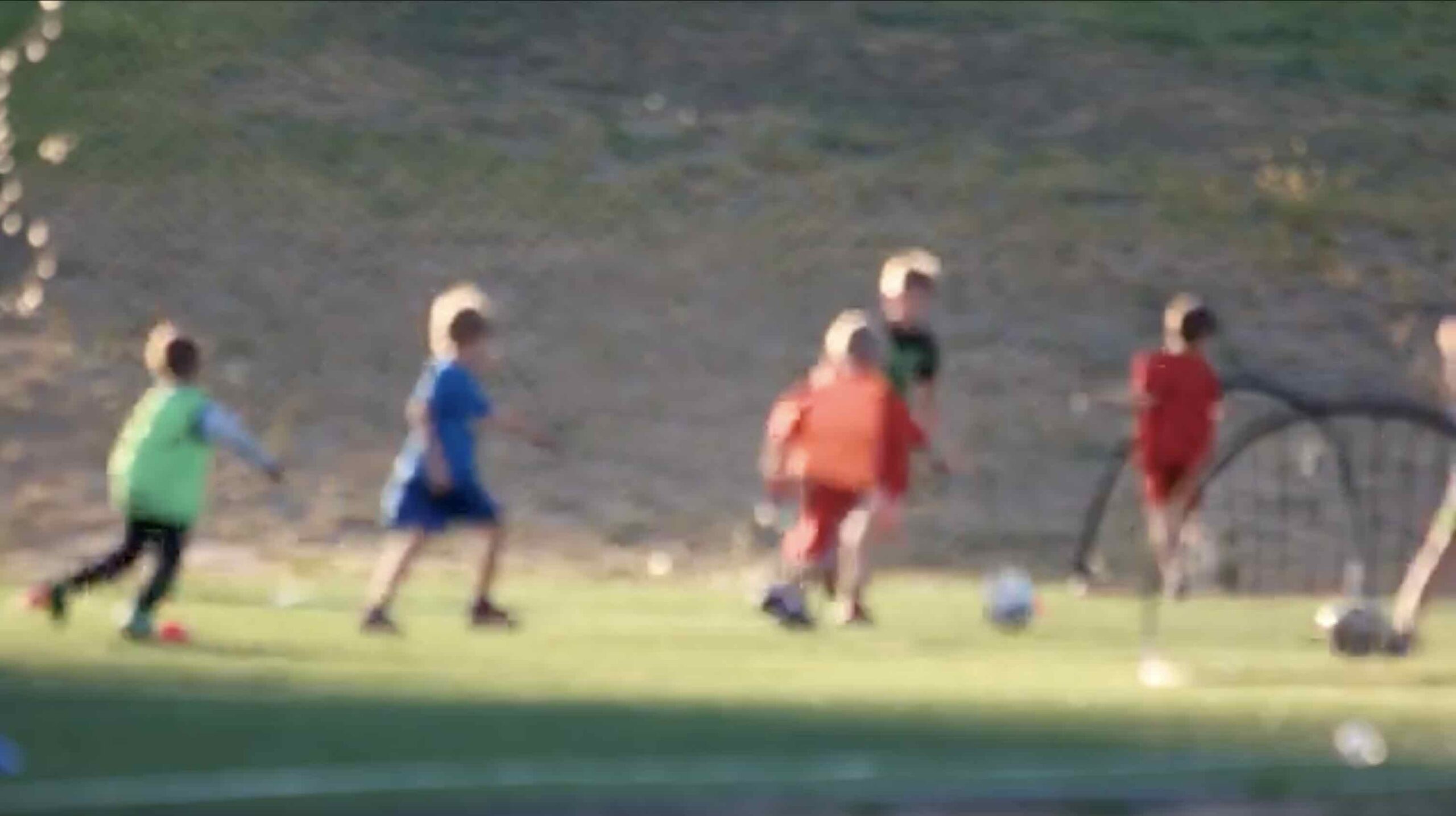 Children playing football in ACE's early neighbourhood work